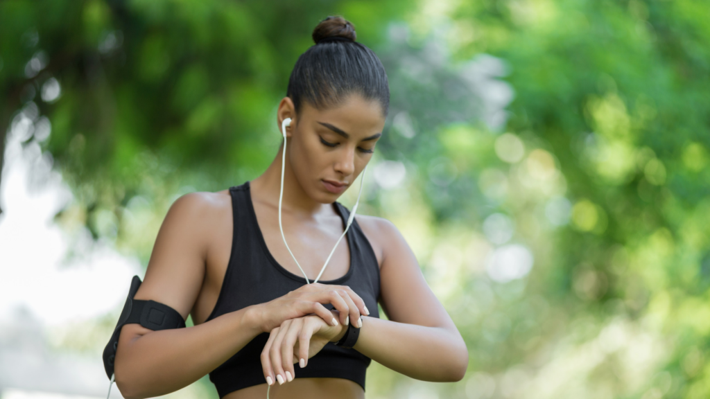 A girl using her smartwatch while doing exercise